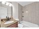 Stylish bathroom featuring a tub and shower combo with tiled walls and a granite countertop vanity at 2412 Giddens Ave, Seffner, FL 33584