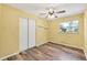 Bedroom features a ceiling fan, neutral paint, luxury vinyl plank flooring and a closet at 2412 Giddens Ave, Seffner, FL 33584