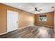 Bedroom featuring neutral paint, modern ceiling fan, wood-look laminate floors and bright window at 2412 Giddens Ave, Seffner, FL 33584