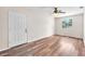 Bright bedroom with wood-look floors, a large window, and a neutral color scheme at 2412 Giddens Ave, Seffner, FL 33584