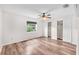 Sunlit bedroom with wood-look floors, a ceiling fan, and ample closet space for storage at 2412 Giddens Ave, Seffner, FL 33584
