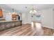 Dining area featuring wood-look floors and which flows into a living room and kitchen with stainless steel appliances at 2412 Giddens Ave, Seffner, FL 33584
