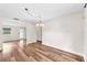 A dining room with wood-look floors and lots of light offering views of the backyard, front yard, and kitchen at 2412 Giddens Ave, Seffner, FL 33584