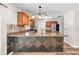 Well-lit kitchen showcasing a stylish island with granite countertops and stainless steel appliances at 2412 Giddens Ave, Seffner, FL 33584