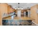 Modern kitchen with stainless steel appliances, granite countertops, tiled backsplash, and a breakfast bar at 2412 Giddens Ave, Seffner, FL 33584