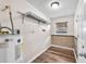 Practical laundry room with water heater and storage shelf, providing functionality and convenience at 2412 Giddens Ave, Seffner, FL 33584