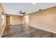 A spacious living room with attractive hardwood floors features a ceiling fan and fresh, neutral paint at 2412 Giddens Ave, Seffner, FL 33584