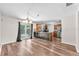 Spacious living room featuring wood-look floors which flow into a kitchen and dining area with backyard views at 2412 Giddens Ave, Seffner, FL 33584
