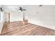 A spacious living room boasts beautiful wood-look floors, neutral paint, a ceiling fan, and flows to other areas at 2412 Giddens Ave, Seffner, FL 33584