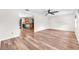 An open-concept living room with wood-look floors that seamlessly connects to a kitchen with a breakfast bar at 2412 Giddens Ave, Seffner, FL 33584