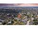 Expansive aerial view of property showing private pool nestled amongst mature trees and lush landscaping in a quiet neighborhood at 2887 North Rd, Clearwater, FL 33760