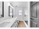 Bright bathroom featuring double sinks, a modern vanity, and a glass enclosed shower with sleek fixtures at 2887 North Rd, Clearwater, FL 33760