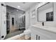 Modern bathroom with black accents, stylish vanity, shower with glass enclosure and neutral decor at 2887 North Rd, Clearwater, FL 33760
