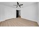 Bedroom featuring ceiling fan, wood floor, closet, and neutral decor at 2887 North Rd, Clearwater, FL 33760