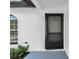 Close up of home's black framed front door and arched window at 2887 North Rd, Clearwater, FL 33760