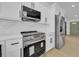 Close up of kitchen with stainless appliances, sleek countertops, white cabinets, and modern hardware at 2887 North Rd, Clearwater, FL 33760