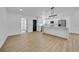 Open-concept kitchen featuring white cabinets, stainless appliances, quartz countertops, and modern lighting at 2887 North Rd, Clearwater, FL 33760
