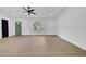 Bright living room featuring sleek ceiling fan, wood floor, large arched window, and neutral decor at 2887 North Rd, Clearwater, FL 33760