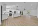 Open floorplan of living space with luxury vinyl plank flooring and view of kitchen at 2887 North Rd, Clearwater, FL 33760