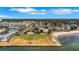 Stunning aerial perspective of a coastal neighborhood with a park, sandy beach, and waterfront access at 3026 51St S St, Gulfport, FL 33707