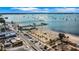 Stunning aerial view showcasing a vibrant beachfront area, a pier, and crystal-clear waters filled with sailboats at 3026 51St S St, Gulfport, FL 33707