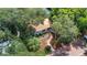 Aerial shot of landscaped front yard, brick walkway, mature trees surrounding property, and roof at 3026 51St S St, Gulfport, FL 33707