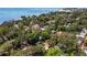 Birds eye view highlighting the house nestled in a canopy of mature trees near the coast at 3026 51St S St, Gulfport, FL 33707