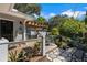 A beautiful back deck with multiple seating areas, a grill, and stone path to backyard at 3026 51St S St, Gulfport, FL 33707