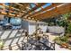 Outdoor space featuring a wooden pergola over a table and chairs, adjacent to a detached shed at 3026 51St S St, Gulfport, FL 33707