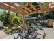 Charming backyard deck with a pergola, seating area, and a variety of plants and decorative items at 3026 51St S St, Gulfport, FL 33707