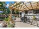 Cozy backyard patio featuring a wooden pergola, outdoor seating, and a variety of potted plants at 3026 51St S St, Gulfport, FL 33707