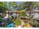 Beautifully landscaped backyard featuring a pergola covered deck, stone pathways, and lush gardens at 3026 51St S St, Gulfport, FL 33707