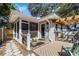 Charming home exterior with a screened porch, wood deck, and landscaped surroundings at 3026 51St S St, Gulfport, FL 33707