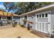 Backyard view featuring a shed with a charming door and a gravel yard leading to a covered deck at 3026 51St S St, Gulfport, FL 33707