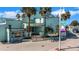 An exterior view of a building with palm trees, a sign, and an inviting entrance in a waterfront location at 3026 51St S St, Gulfport, FL 33707