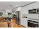 Open layout kitchen with stainless steel appliances and a view of the living room at 3026 51St S St, Gulfport, FL 33707
