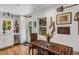 Charming eat-in kitchen with white cabinets, stainless appliances, wood floors and decorative wall art at 3026 51St S St, Gulfport, FL 33707