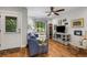 Bright living room features hardwood floors, a comfortable blue couch, and large windows at 3026 51St S St, Gulfport, FL 33707
