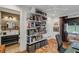 Office with a built-in bookshelf, desk and chair, and a view into an adjacent bathroom at 3026 51St S St, Gulfport, FL 33707