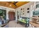 Charming patio with wood ceiling, vintage cabinet, comfortable seating, and decorated wall art at 3026 51St S St, Gulfport, FL 33707