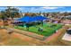 Community playground featuring covered picnic tables and plenty of modern colorful equipment in a securely fenced area at 3026 51St S St, Gulfport, FL 33707