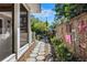 Beautiful side yard featuring stone pavers, bamboo fence, and an artistically decorated fence at 3026 51St S St, Gulfport, FL 33707