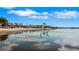 Scenic waterfront view with herons standing in the water reflecting a clear blue sky at 3026 51St S St, Gulfport, FL 33707