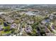 A bird's eye view of a neighborhood displays mature landscaping, waterways, and surrounding buildings at 3050 Landmark Blvd # 1008, Palm Harbor, FL 34684