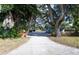 Long driveway leads to a cozy home with mature landscaping and a fenced yard at 3515 18Th E St, Bradenton, FL 34208