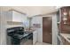 Kitchen with a black range and built-in white cabinets at 3515 18Th E St, Bradenton, FL 34208