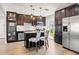 Modern kitchen featuring dark wood cabinets, stainless steel appliances, and a central island with stylish seating at 3632 27Th Ave N, St Petersburg, FL 33713