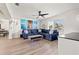 Spacious living room featuring a blue sectional sofa, a view to the dining area and large window at 3632 27Th Ave N, St Petersburg, FL 33713