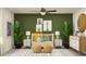 Charming Bedroom with green walls, a wooden crib, safari themed artwork, and woven ottomans on a patterned rug at 3646 Forest Path Dr, Plant City, FL 33565