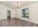 Bright dining room featuring wood-look floors, modern lighting, and a large window at 3682 Johnstown St, North Port, FL 34288